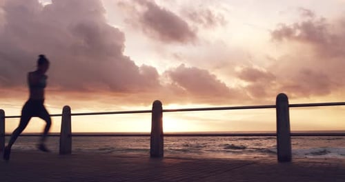 Woman, sunset and silhouette with running at beach for fitness, speed and action with training
