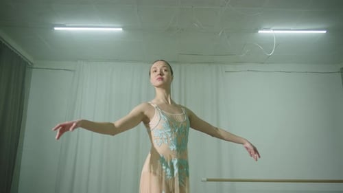 Ballerina Dances in the Hall in a Delicate Translucent Dress
