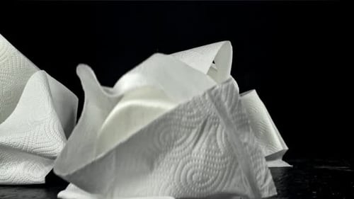 Toilet Paper Falls on the Table On a Black Background Filmed on a Highspeed Camera at 1000 Fps