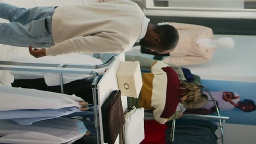 Adults Shopping For Clothes in a Modern Clothing Store