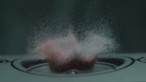 Speaker Vibrating with Pink and Orange Sand