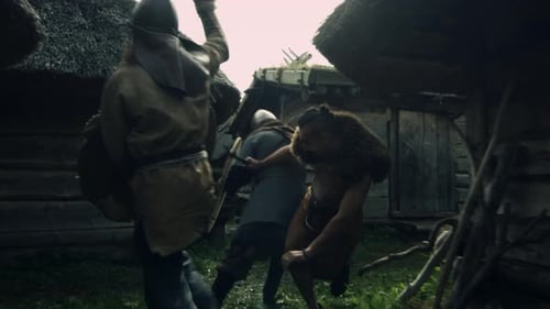 Warriors are Fighting during Attack on Village during Slavs and Vikings Festival. Medieval Reenactm