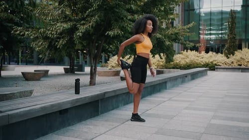 Cheerful Woman Stretching Gracefully on Empty City Street