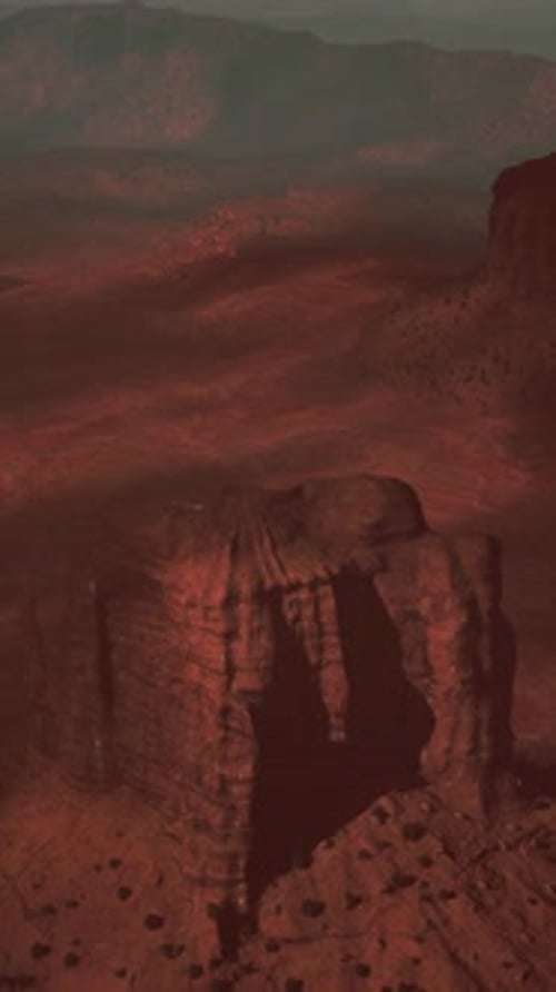 Aerial View of Rocky Outcropping With Mountains