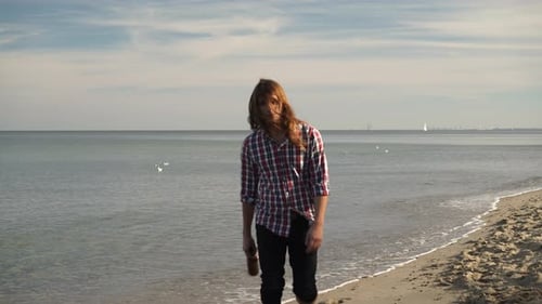 Man With Wine Bottle Walking On Beach