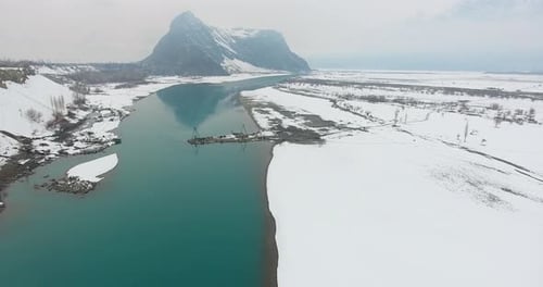 Aerial view of snowy mountain valley in winter, Pakistan.