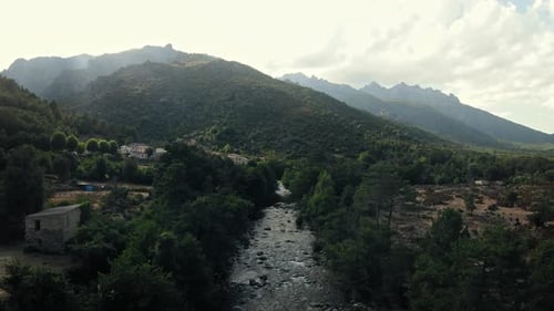 Slow flight between the trees and following a river in Corsica