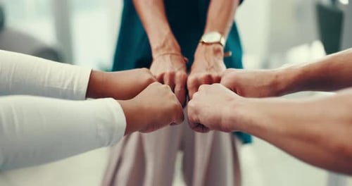 Team Fists Bump in Office Workplace Setting