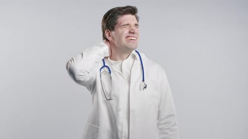 Tired Doctor Man Feeling Pain in Neck Joint Massaging Muscles Rubbing Head