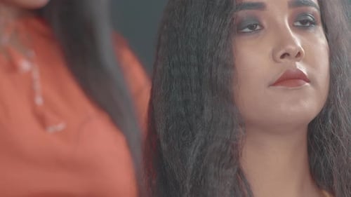 Close Up Of Hair Styling With Straightening Iron