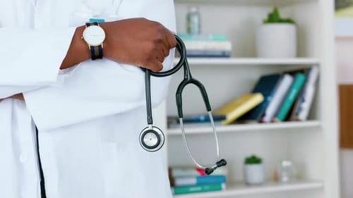 Doctor Holding Stethoscope in Modern Medical Clinic