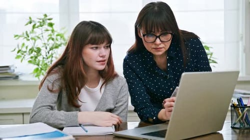 Girl and Woman Looking at Laptop Computer Screen