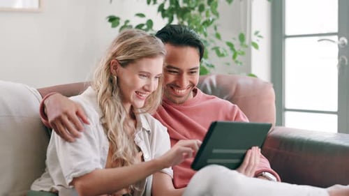 Young Couple Using Tablet Together on Couch