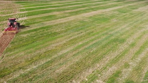 Red tractor working on the field in Spain making tillage