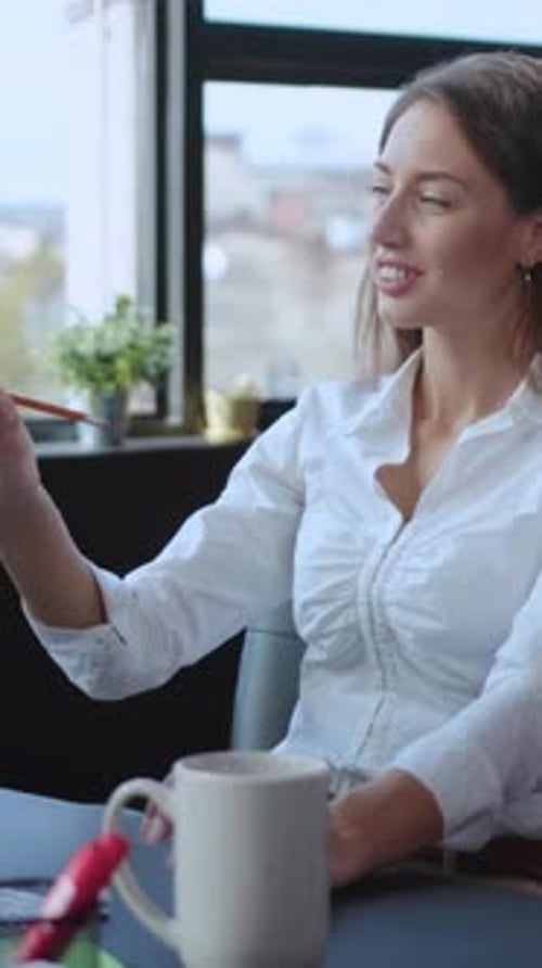 A Professional Woman Engaged and Absorbed in Her Work in a Modern Office Environment