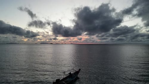 Aerial shot of a drone motorboat flying forward over the sea during sunset