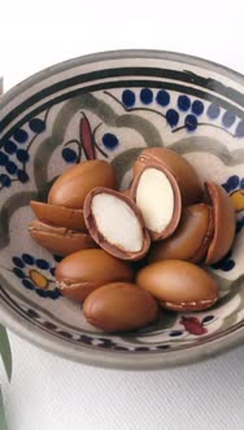 Argan Nuts Spinning on White Background