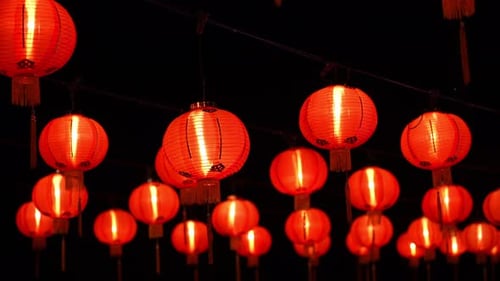 Illuminated red chinese lanterns glowing at night