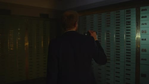 Man Investigating Dark Vault Interior with Flashlight