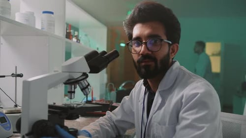 Male Scientist Using Microscope in a Laboratory
