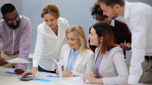 Business team meeting discussing project with documents in office
