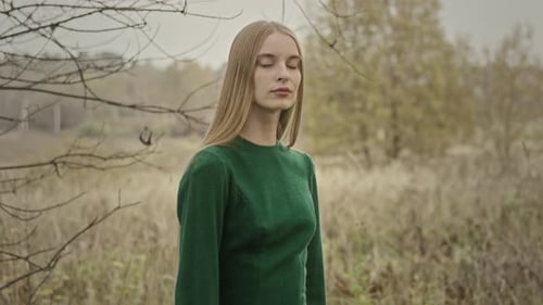 Model posing wearing green dress in autumn