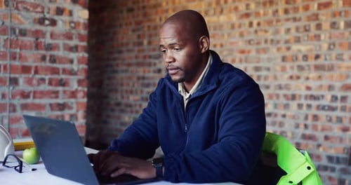 Building, laptop and stress with black man on construction site for planning or problem solving