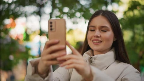 Smiling Woman Recording Casual Video Woman in Park Taking Smiling Selfie with Smartphone Casual
