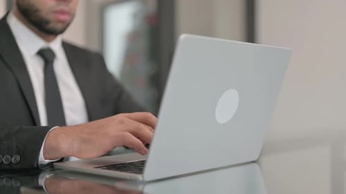 Close up of Businessman Typing on Laptop