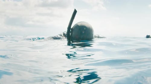 Freediver Relaxes in the Water and Prepares for His Dive From Platform Drifting in the Open Sea