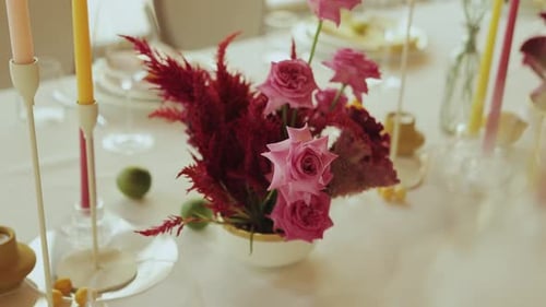 Elegant floral centerpiece with pink roses on table