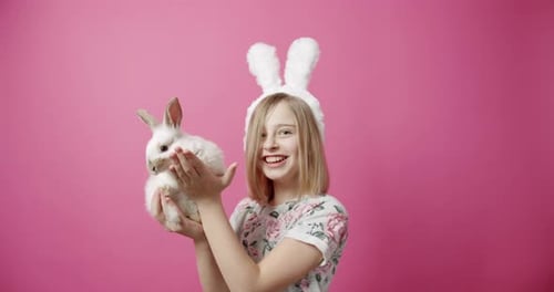 Girl with Bunny Cuddles her Pet Rabbit