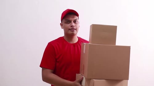 Young asian deliveryman standing while holding cardboard box