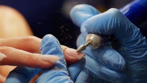Close Up of Manicurist Filing Client's Fingernail