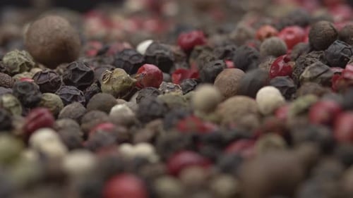 Black peppercorns texture. The peppercorns slider falls into a huge pile