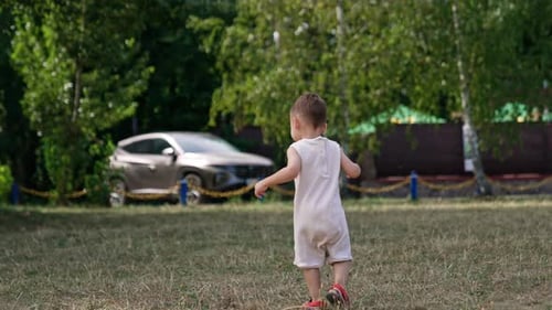 Happy Child Walking in a Park on a Sunny Day