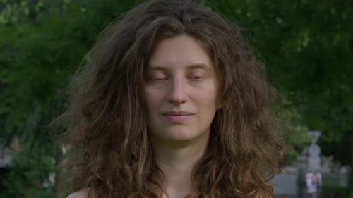 Woman with Curly Hair Posing Outdoors