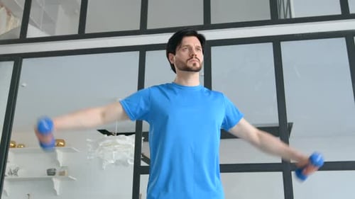 Man Doing Dumbbell Exercises in Bright Home Interior