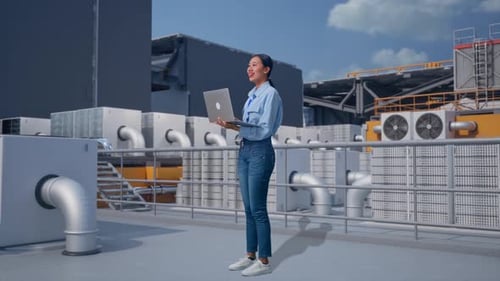 Young Woman Using Laptop on Rooftop with AC Units