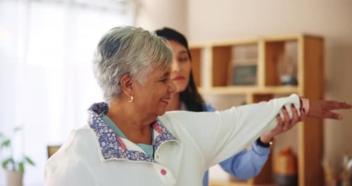 Senior Woman Receiving Arm Exercise Assistance at Home