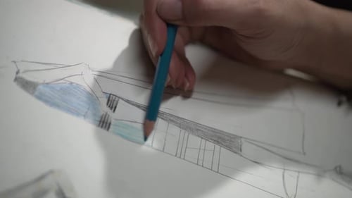 Fashion Designer Hand Drawing Sketch With Colored Pencil