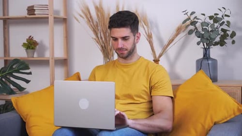 Young Adult Working on Laptop at Home