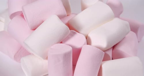 White and Pink Marshmallow, Rotation in Circle. Marshmallow for Cocoa or for Grilling, Turning