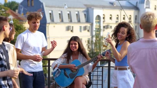 Friends Enjoying Rooftop Party with Music
