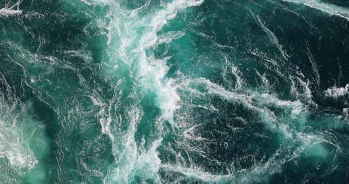 Blue waves of water of the river and the sea meet each other during high tide and low tide.