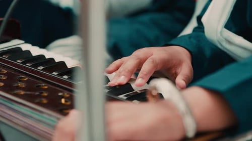 Indian Child Hands Plays Sikh Prayer Music with Harmonium Keyboard During Vaisakhi