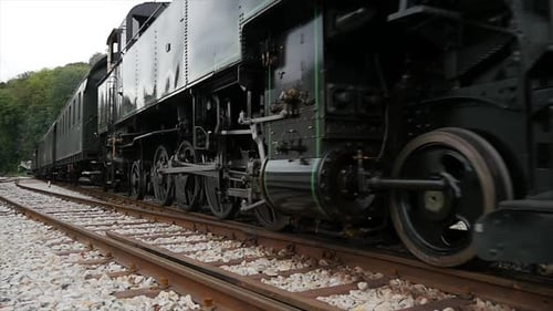Historical Steam Engine Train Locomotive Driving on Railroad Tracks