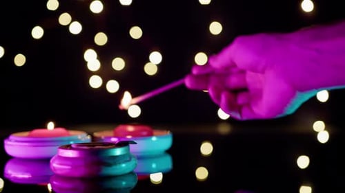 Diwali Candles Lit with Sparkler on Dark Background
