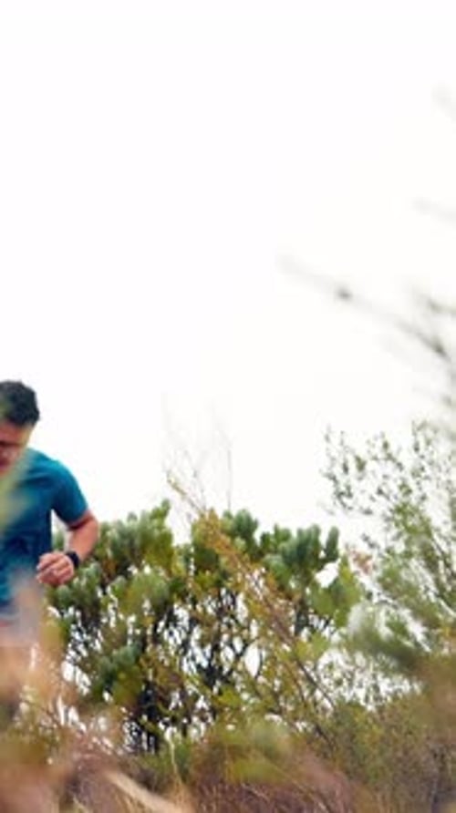 Athletic Young Man Running Outdoor Trail in Nature