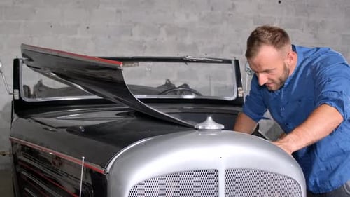 Male Mechanic Servicing Car in Garage Car Service